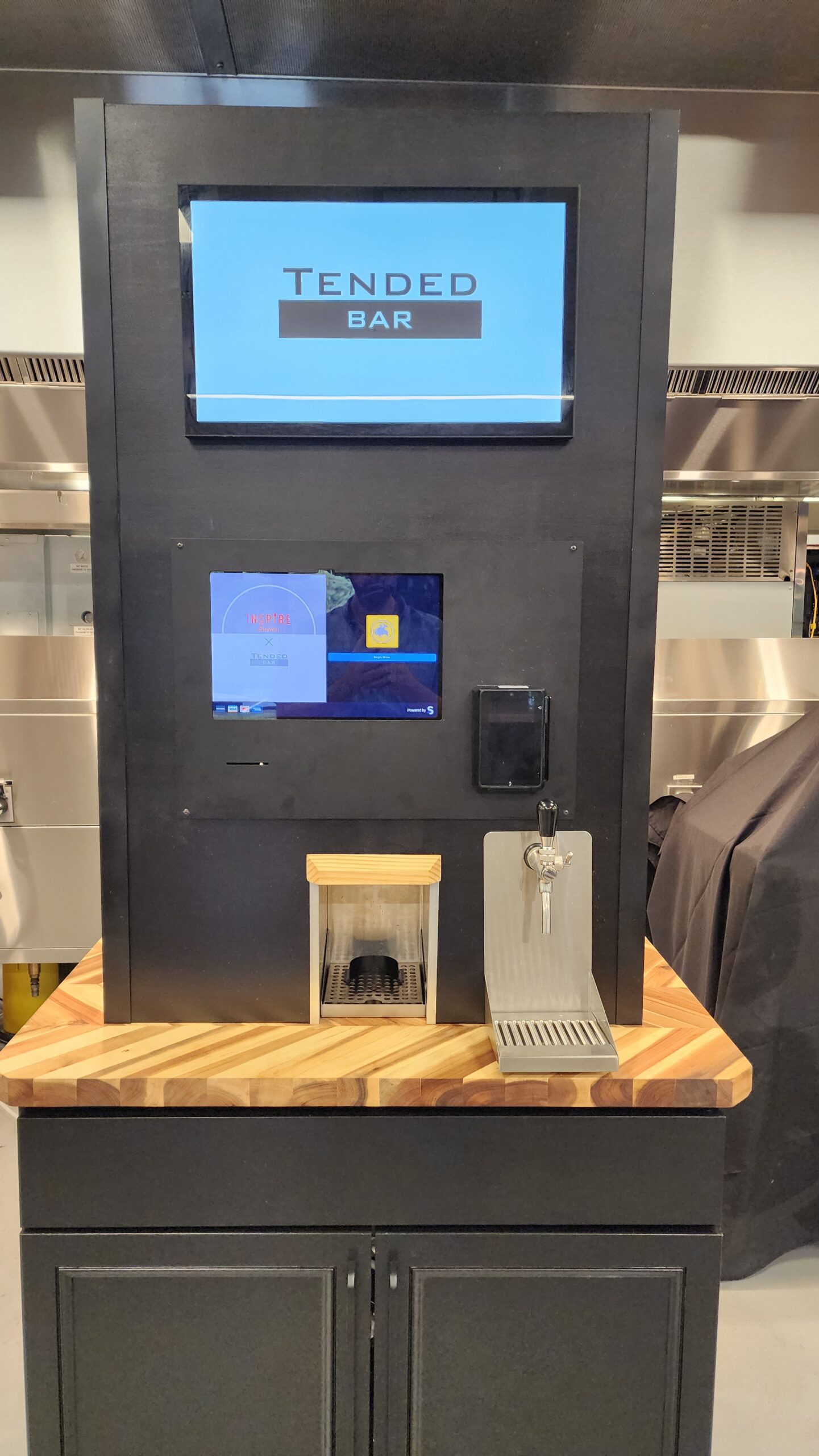 Wall-mounted TendedBar beverage dispenser showing installation hardware and touchscreen