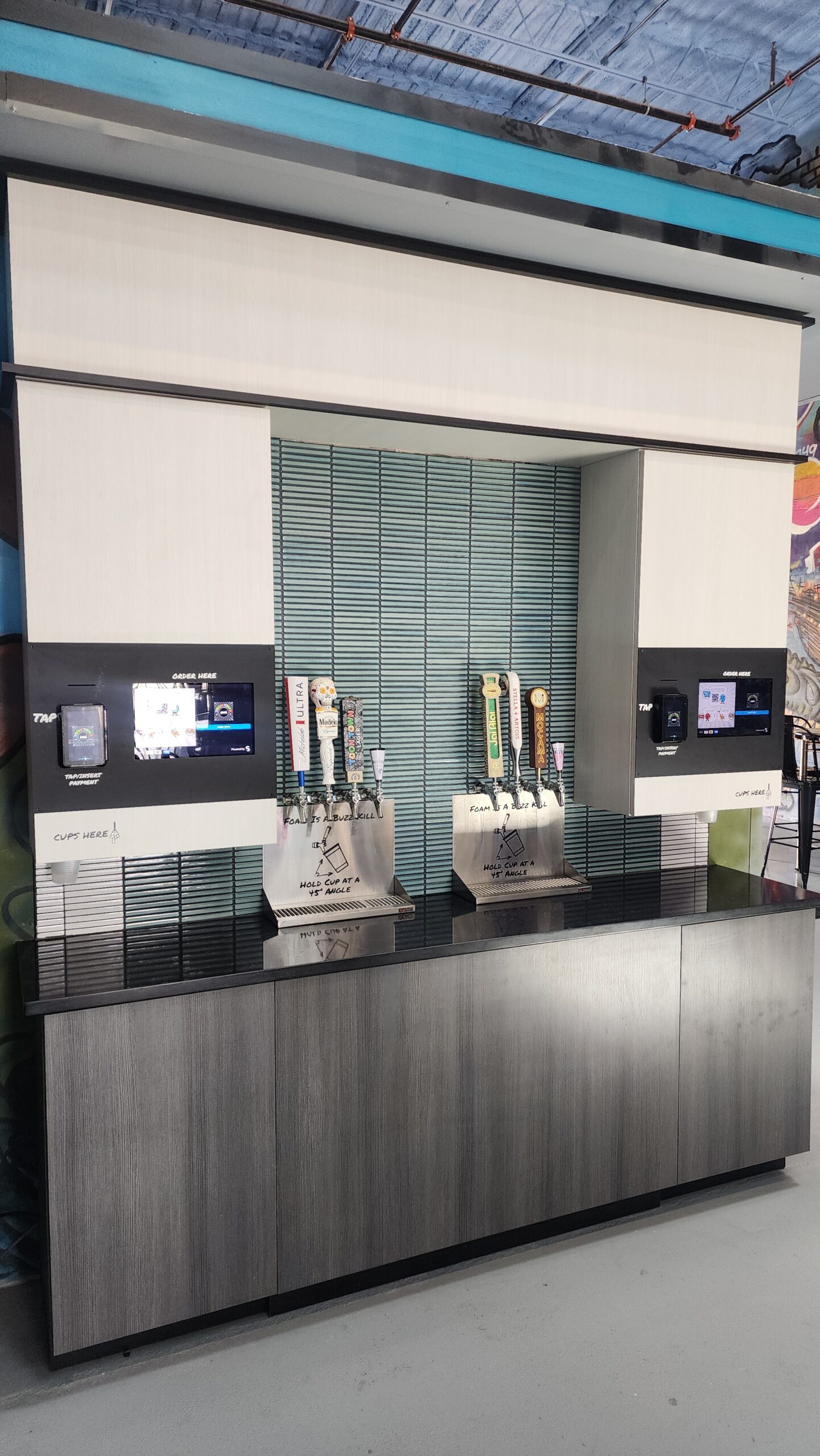 TendedBar multi-tap dispensing wall with beverage variety and touchscreen ordering panel